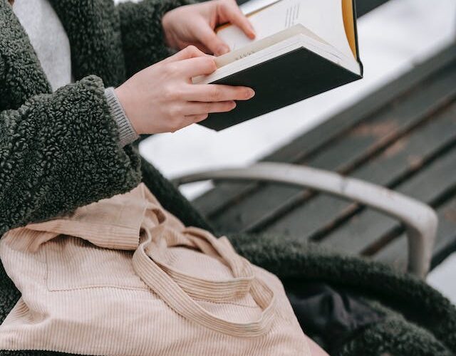 Reading a book outside a winter weather