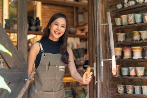 A friendly woman welcoming a customer with a warm smile, creating a positive and welcoming atmosphere during their visit.